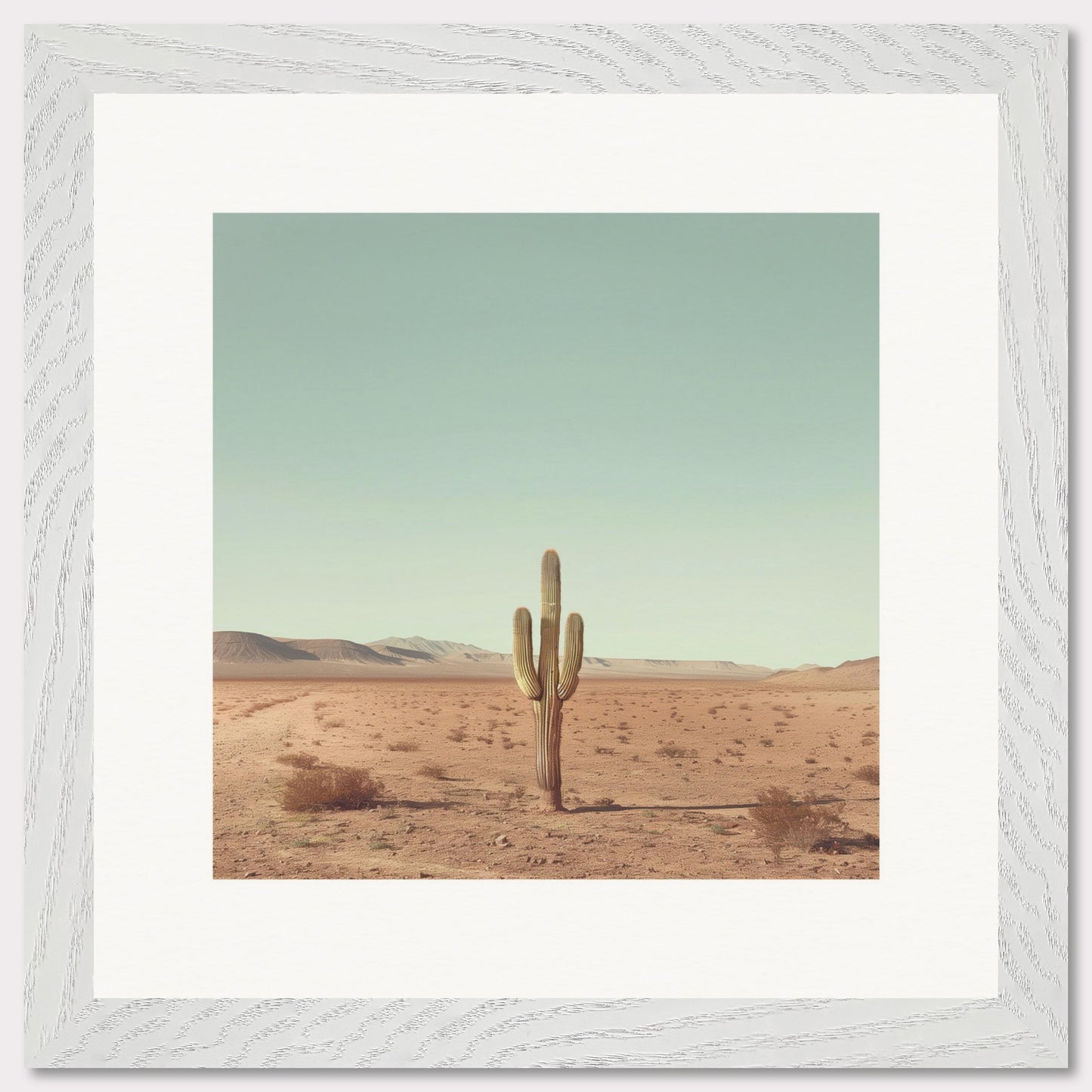 This serene photograph captures the solitary beauty of a lone cactus standing tall in a vast desert landscape. The clear blue sky stretches endlessly above, while distant mountains create a tranquil backdrop. The image is framed in a simple, elegant black border, enhancing its minimalist appeal.