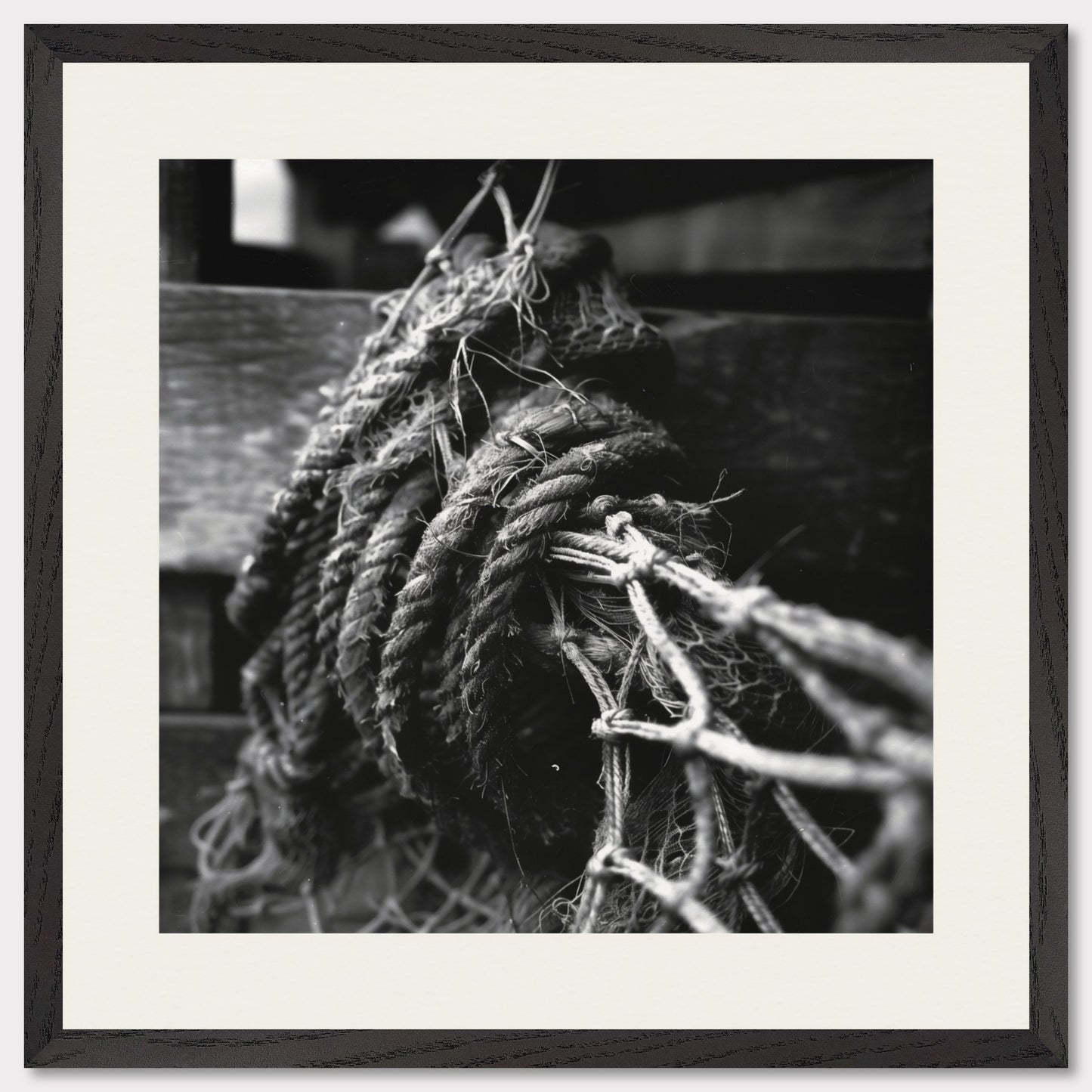 This is a black and white illustration of coiled ropes and fishing nets. The image captures the textures and details of the ropes and nets, emphasizing their rough and worn appearance.