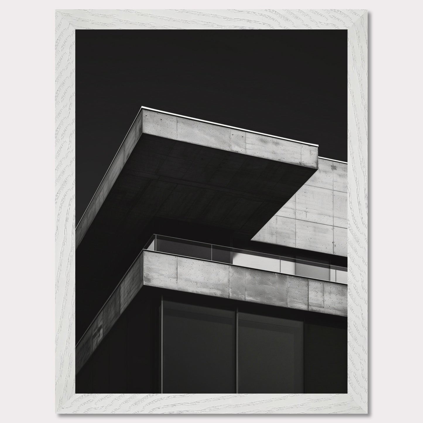 This striking black and white photograph captures the modern architectural lines of a concrete building against a dark background. The image highlights the stark contrast and geometric precision of contemporary design.