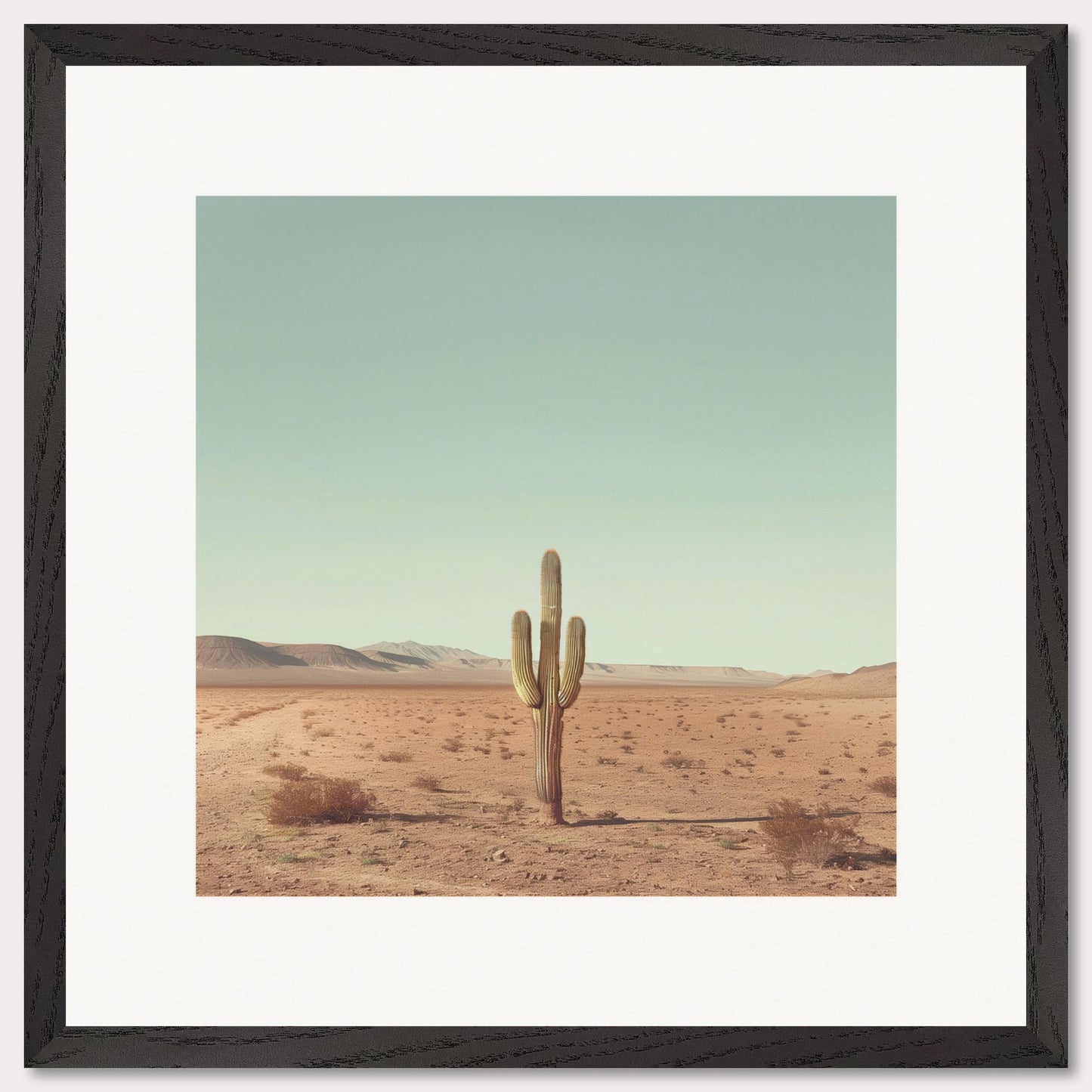 This serene photograph captures the solitary beauty of a lone cactus standing tall in a vast desert landscape. The clear blue sky stretches endlessly above, while distant mountains create a tranquil backdrop. The image is framed in a simple, elegant black border, enhancing its minimalist appeal.