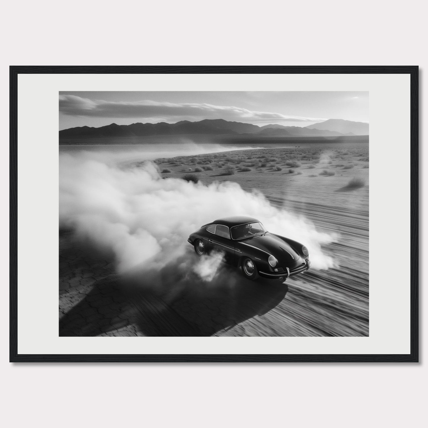 This striking black and white photograph captures a classic car speeding through a desert landscape, leaving a trail of dust in its wake. The image exudes a sense of freedom and adventure, with the distant mountains adding to the dramatic scenery.