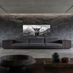 Alpine Cow Majesty – Alu-Dibond wall art showcased above a modern gray sofa in a minimalist living room.