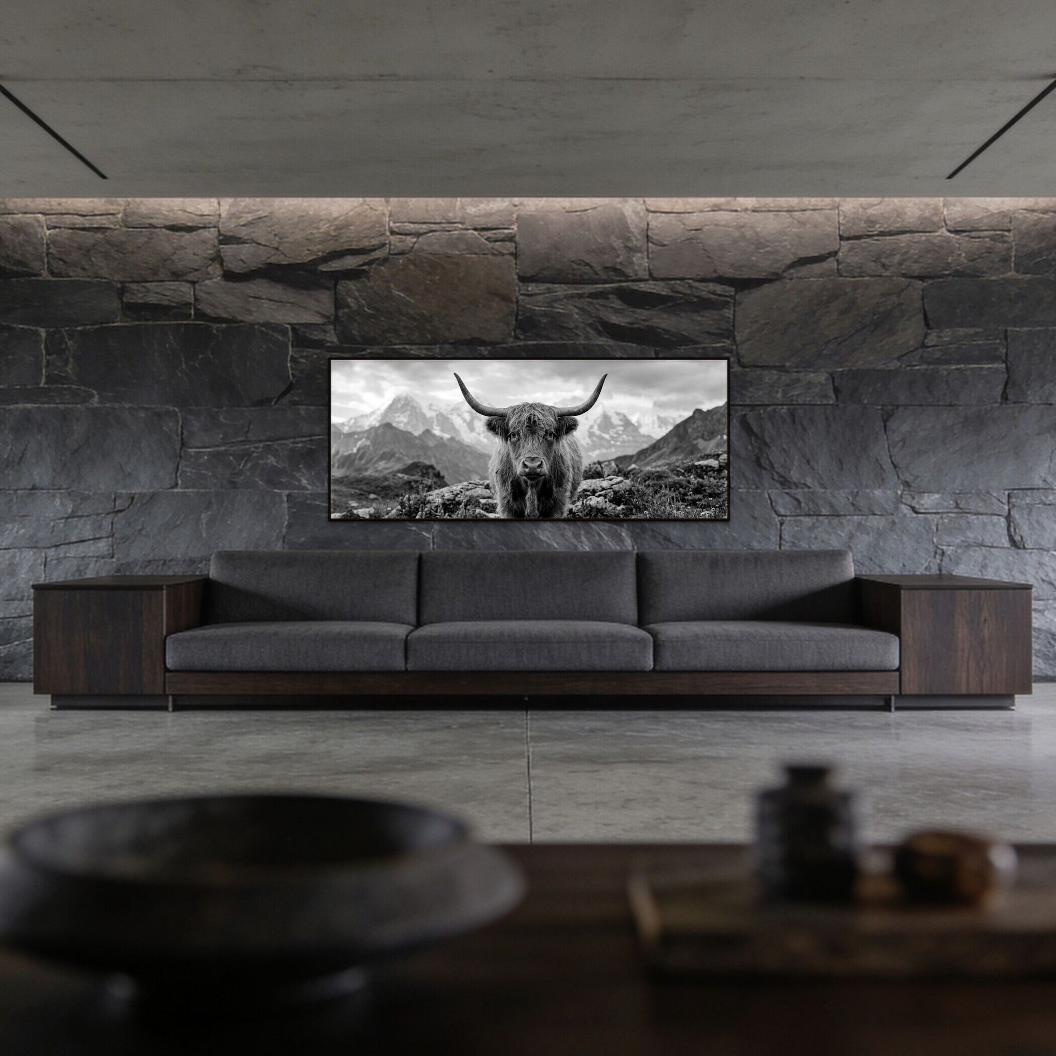 Alpine Cow Majesty – Alu-Dibond wall art showcased above a modern gray sofa in a minimalist living room.