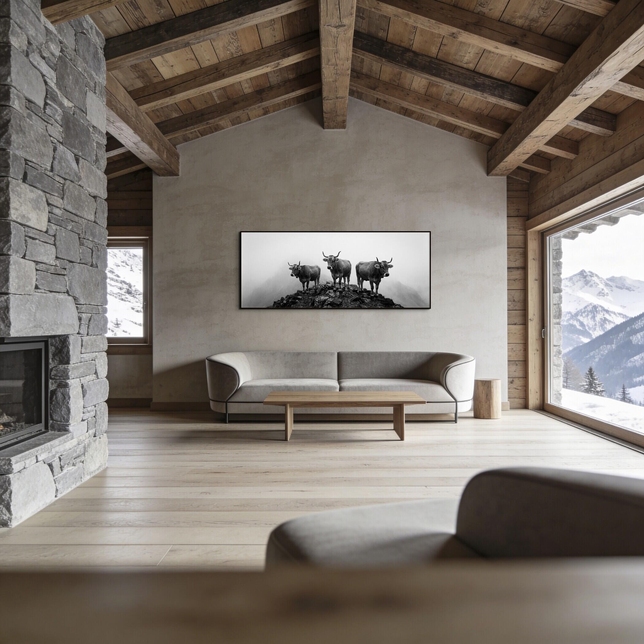 Alpine Cows Mist – Alu-Dibond wall art displayed in a modern alpine living room with wooden beams and stone fireplace.