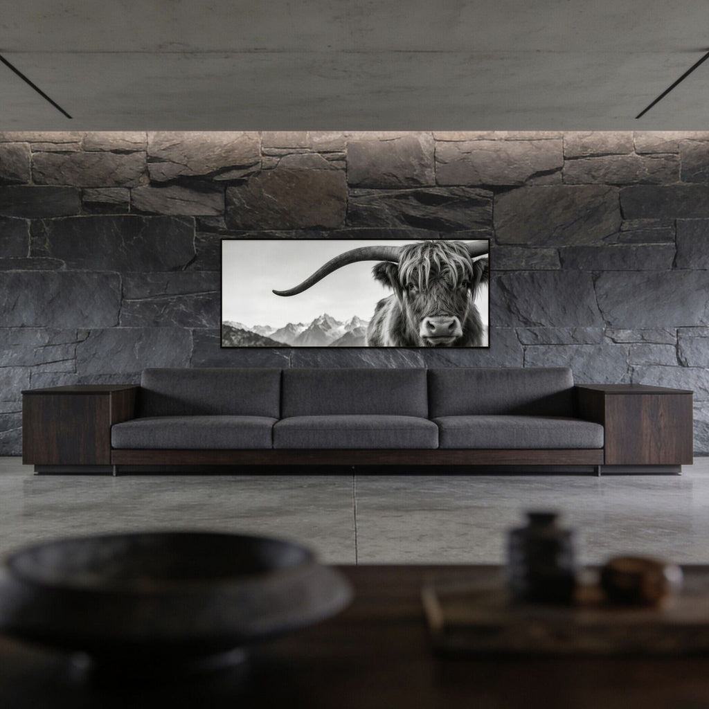 Alpine Horned Beauty – Alu-Dibond wall art displayed above a modern gray sofa in a minimalist living room, featuring an Alpine cow.