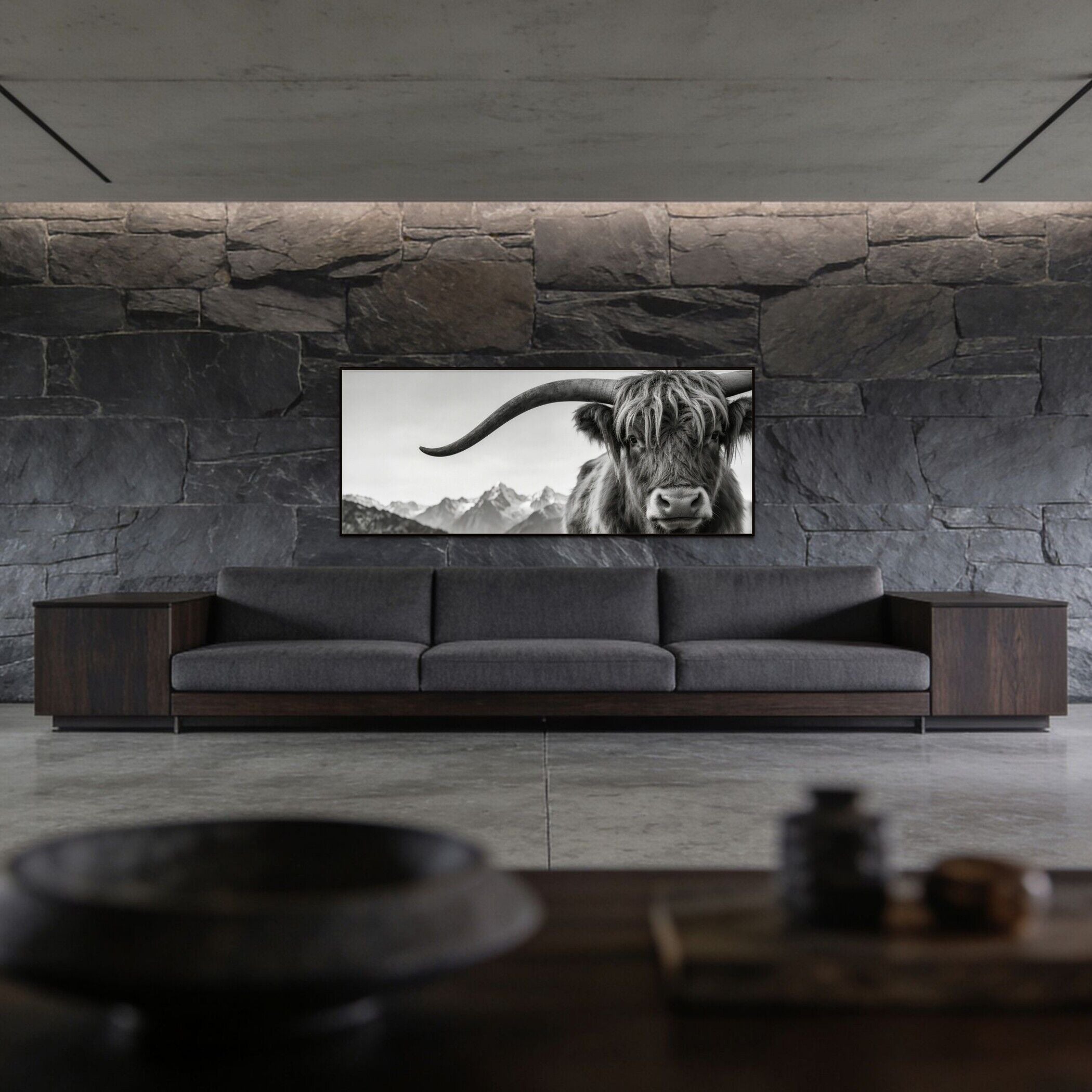 Alpine Horned Beauty – Alu-Dibond wall art displayed above a modern gray sofa in a minimalist living room, featuring an Alpine cow.