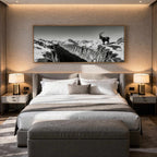 Alpine Ibex Horizon – Alu-Dibond wall art above a modern bedroom showcasing a solitary ibex and dramatic mountain scenery.
