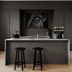 Wolf Eye Reflection – Alu-Dibond wall art displayed in a modern kitchen with marble island and black stools.
