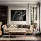 Wolf Eye Reflection – Alu-Dibond wall art displayed above a beige sofa in a bright living room.
