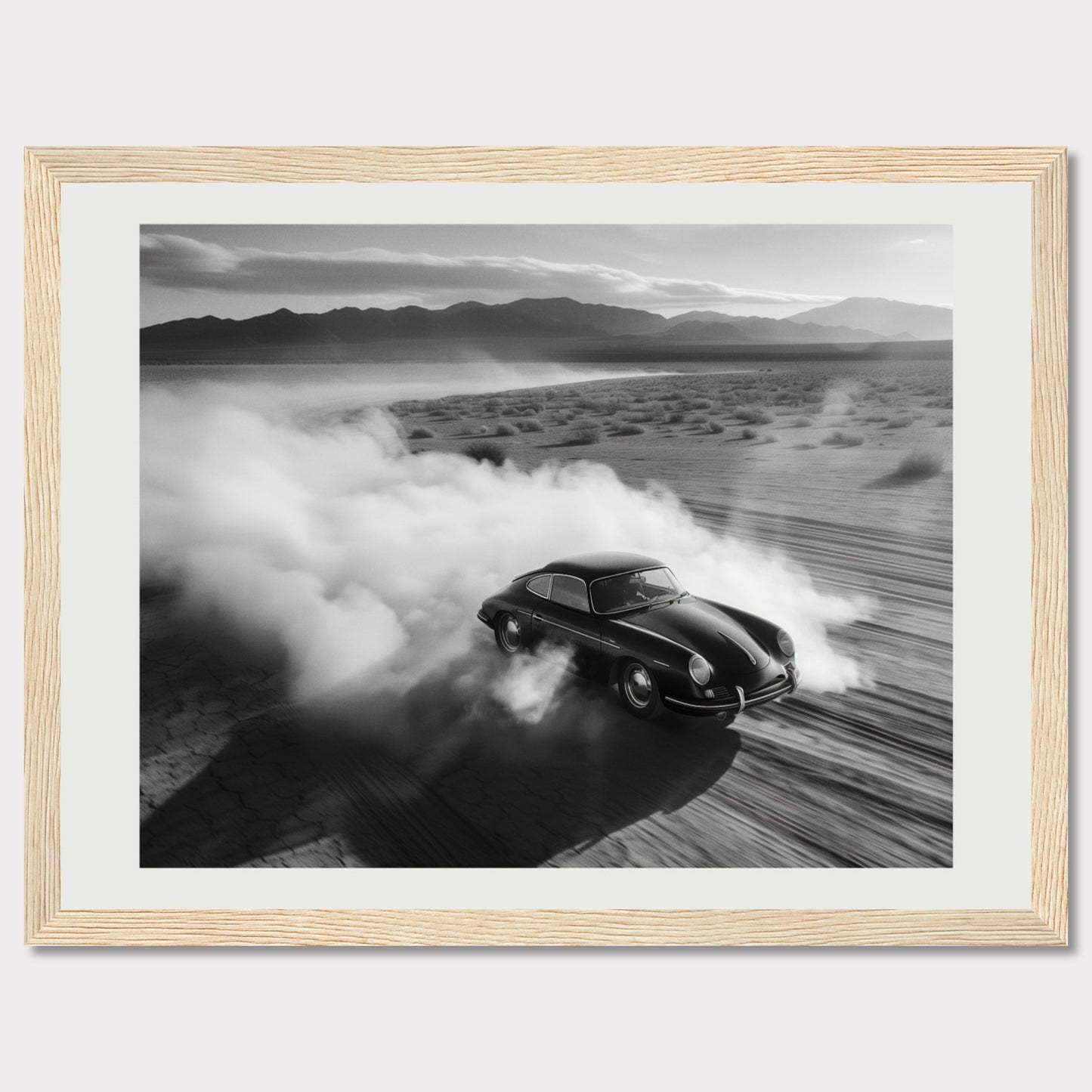 This striking black and white photograph captures a classic car speeding through a desert landscape, leaving a trail of dust in its wake. The image exudes a sense of freedom and adventure, with the distant mountains adding to the dramatic scenery.