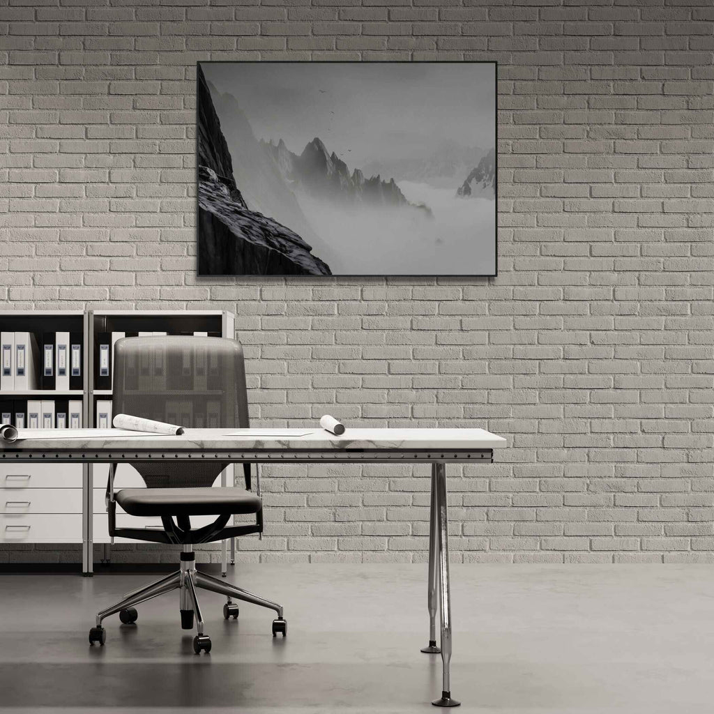 Above the Clouds – Alu-Dibond wall art showcasing serene alpine peaks in a modern office setting.