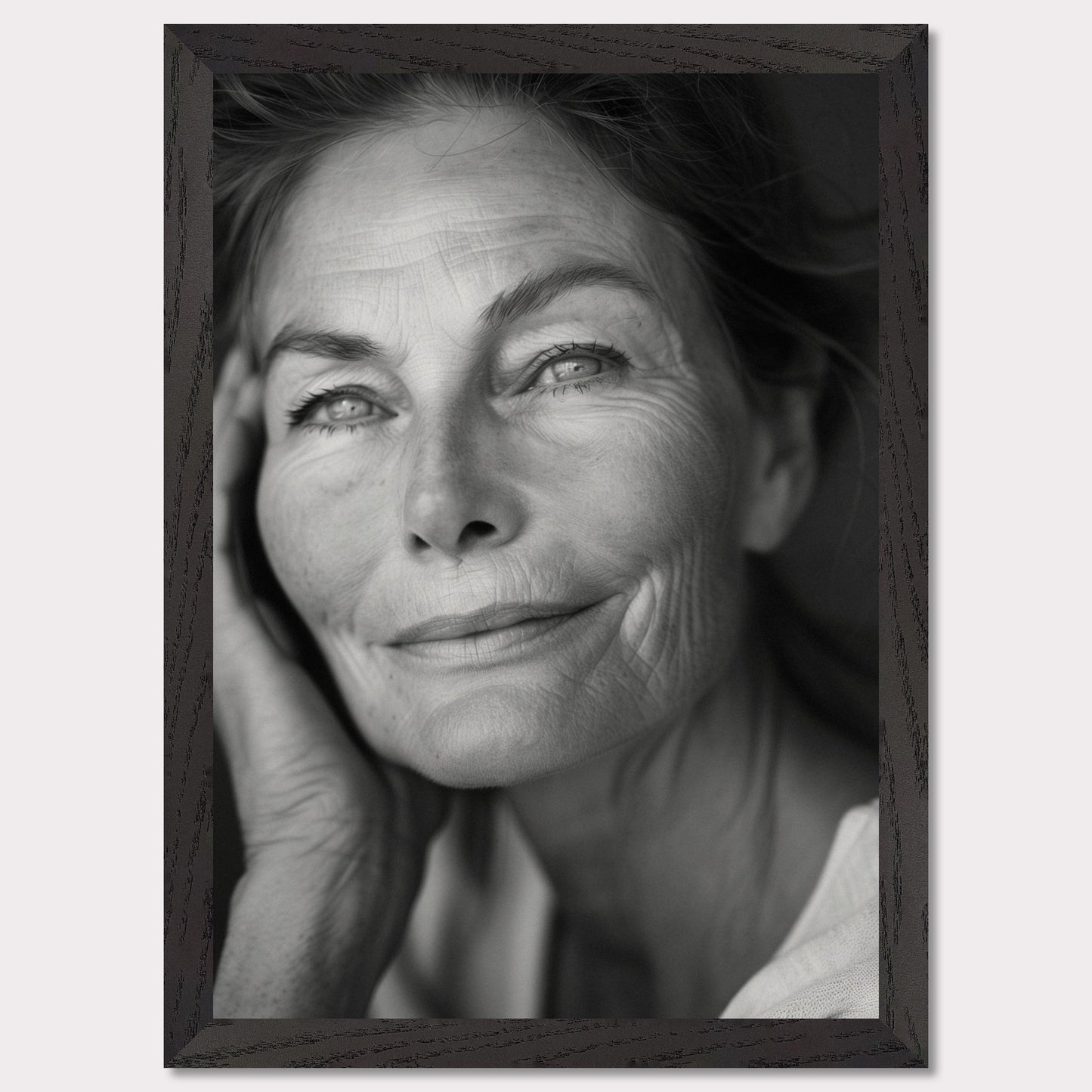 This captivating black-and-white portrait captures the serene and wise expression of an elderly woman. Her gentle smile and thoughtful gaze evoke a sense of peace and contentment. The fine lines on her face tell a story of a life well-lived, filled with experiences and wisdom.