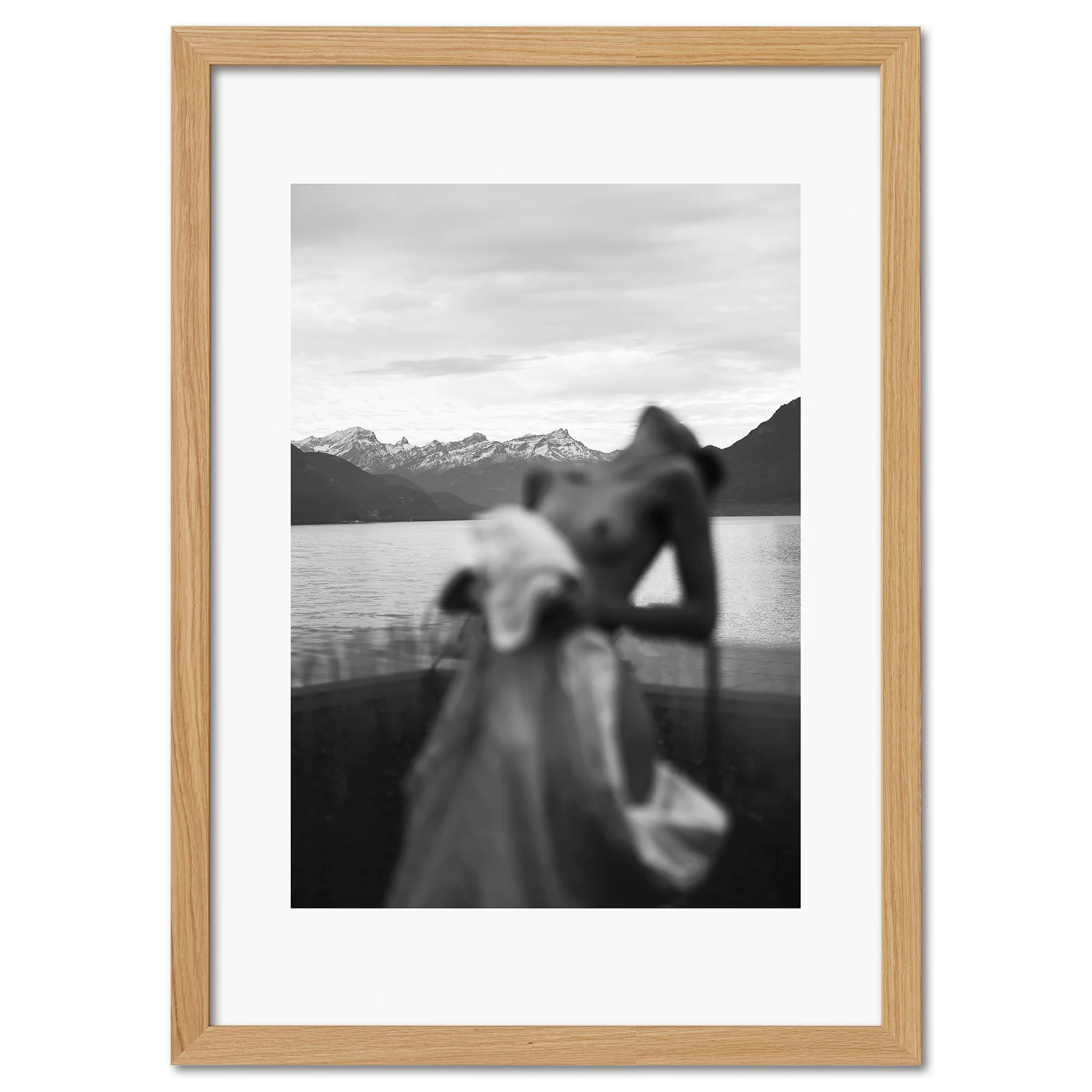 Alpine Silhouette - Poster featuring a blurred silhouette of a woman with snowy mountains and a lake in black and white.
