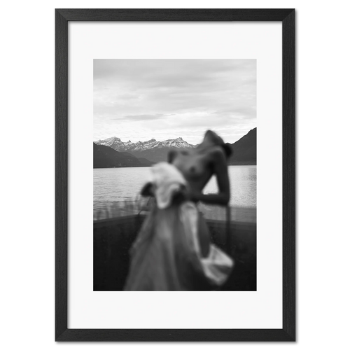 Alpine Silhouette - Poster featuring a blurred woman silhouette by a serene lake with snowy mountains.