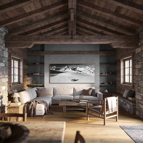 Alpine Cabin in Silence – Alu-Dibond wall art displayed in a cozy rustic interior with wooden beams and stone walls.