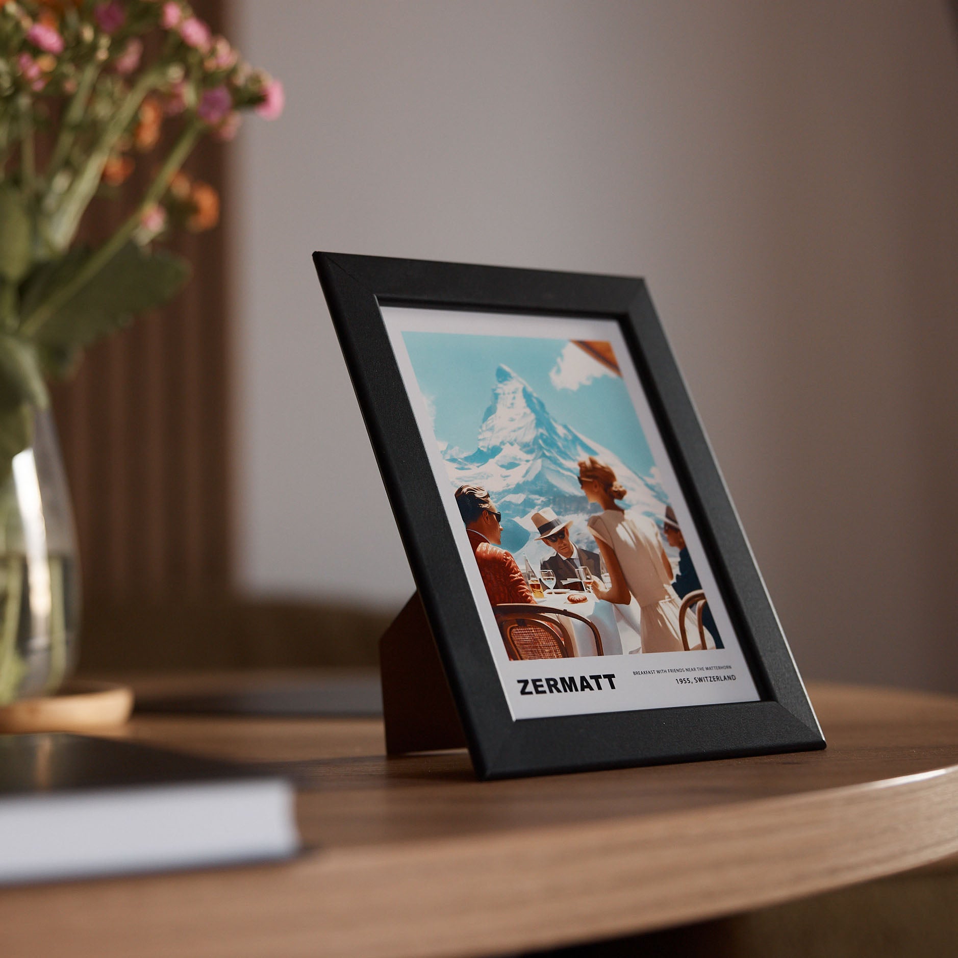 Breakfast in Zermatt – Édition Petite framed print on a desk with a mountain view in the background, capturing a serene moment.