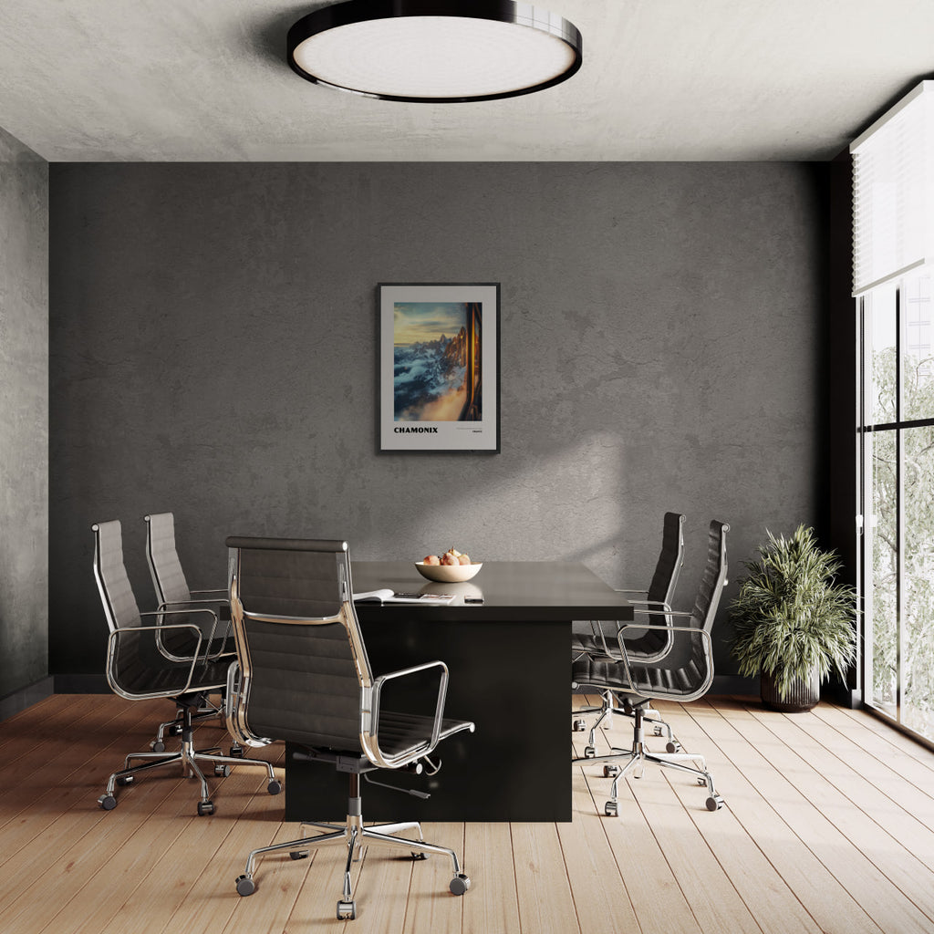 Chamonix - The Heart of the French Alps - Poster displayed in a modern conference room with stylish chairs.