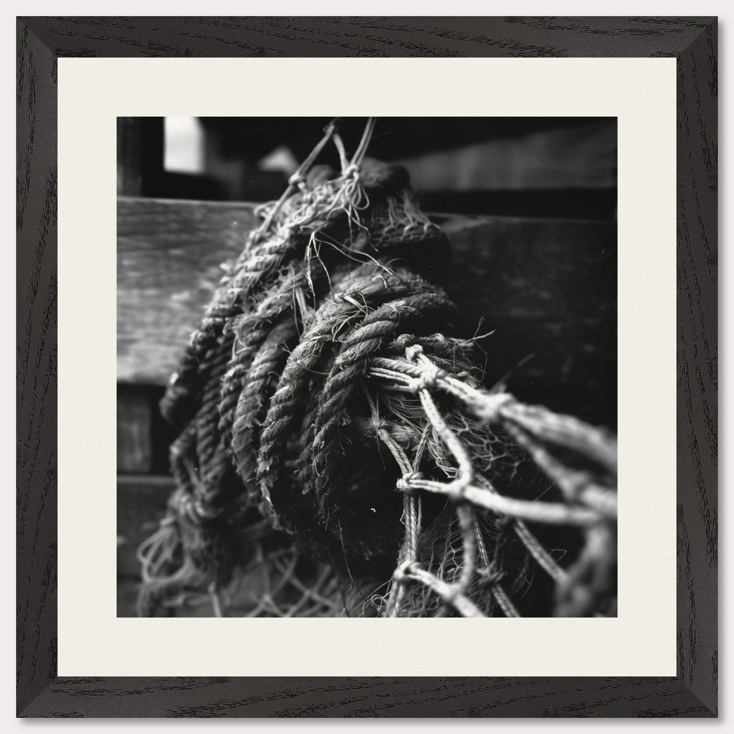 This is a black and white illustration of coiled ropes and fishing nets. The image captures the textures and details of the ropes and nets, emphasizing their rough and worn appearance.