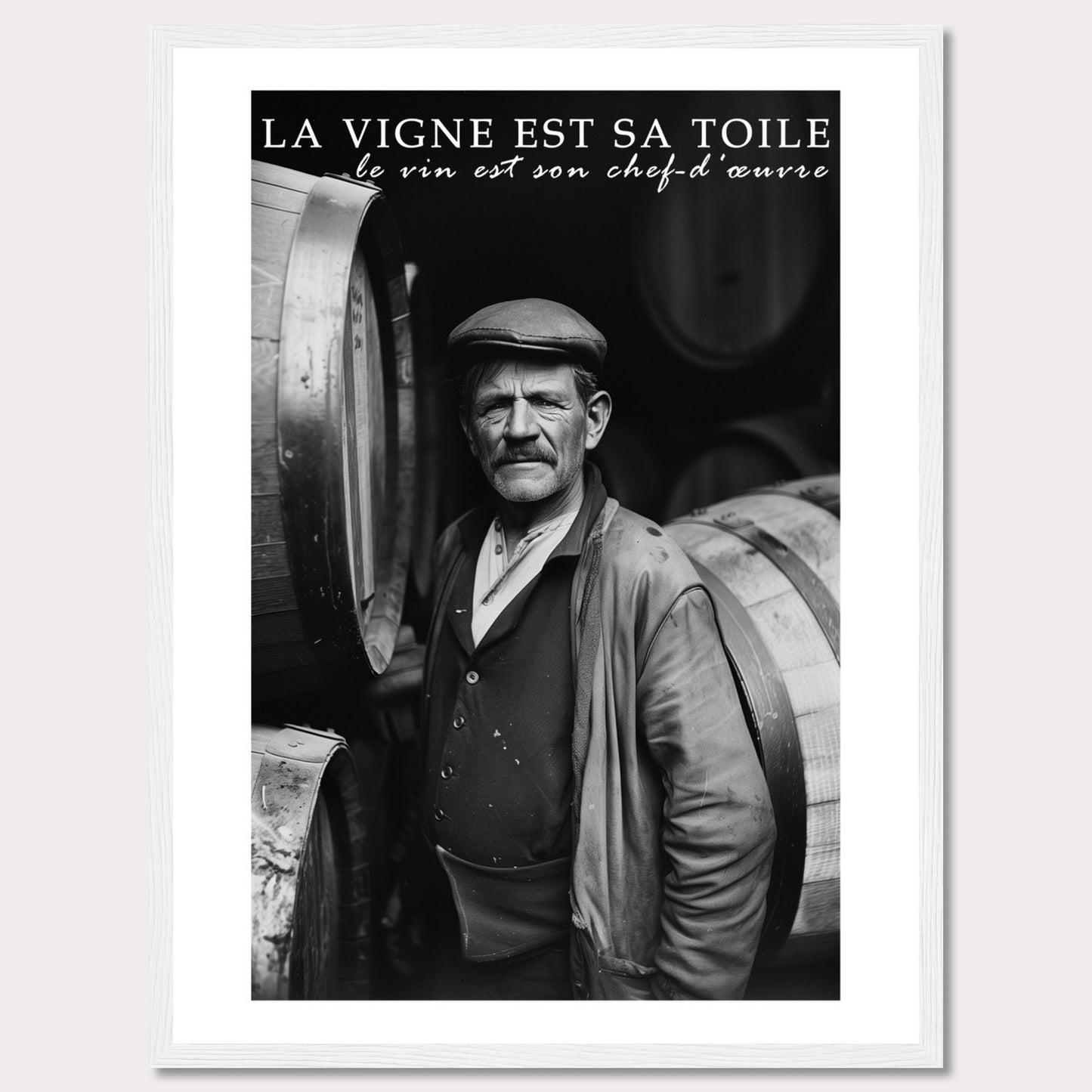 This striking black-and-white photograph captures a seasoned winemaker standing proudly among wine barrels. The text above reads, "La vigne est sa toile, le vin est son chef-d'œuvre," which translates to "The vineyard is his canvas, the wine is his masterpiece." The image exudes a sense of dedication and craftsmanship.