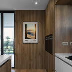 Davos - A Moment Suspended in Light - Poster framed in a modern kitchen interior with wooden accents.