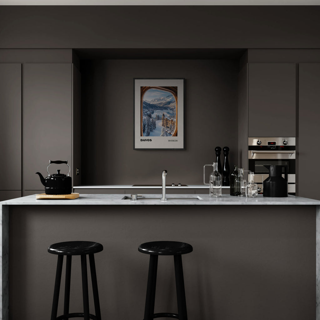 Davos - A View That Stays With You - Poster displayed in a modern kitchen with dark cabinets and marble countertop, enhancing wall art decor.