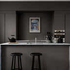 Davos - A View That Stays With You - Poster displayed in a modern kitchen with dark cabinets and marble countertop, enhancing wall art decor.