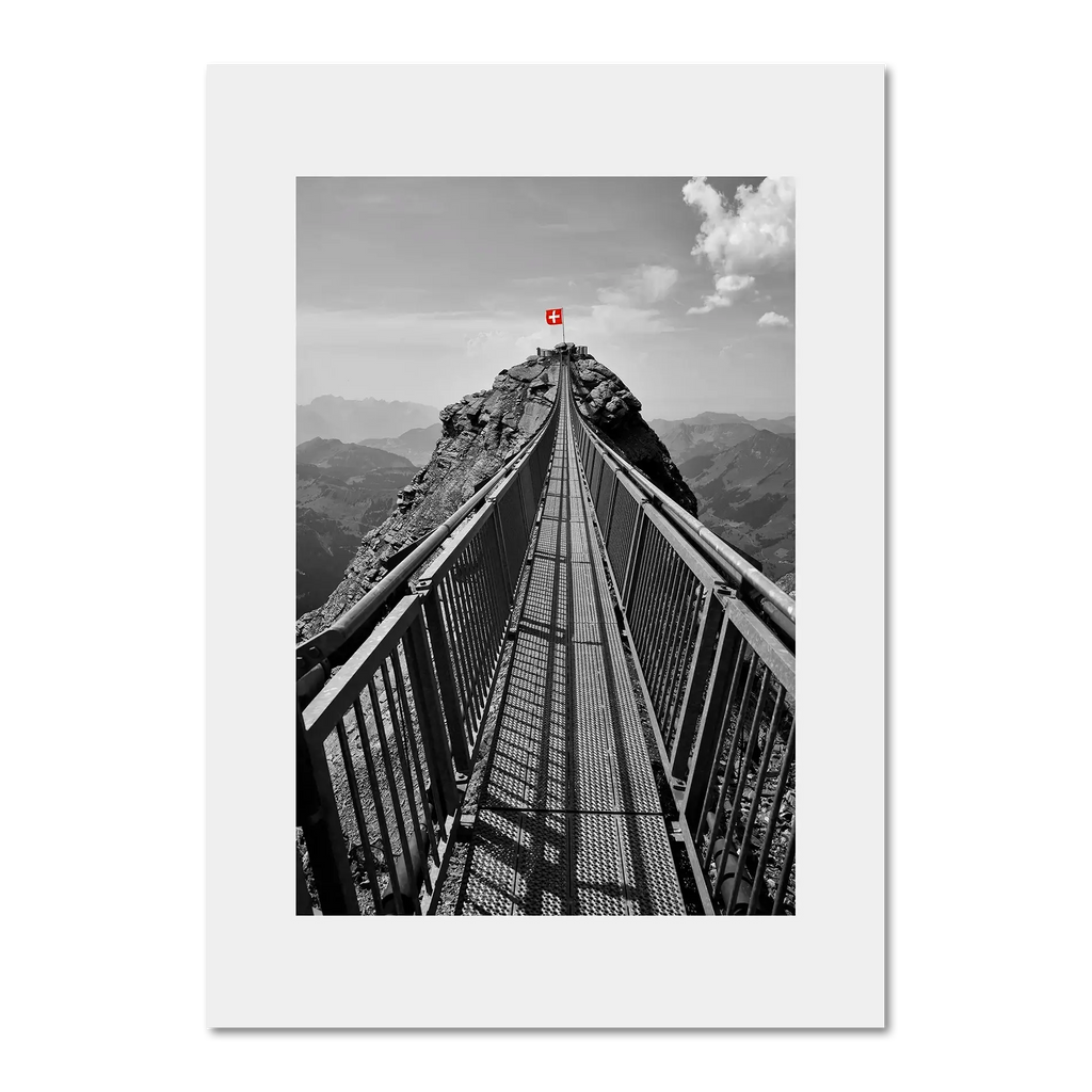 Glacier 3000 Suspension Bridge - Poster showcasing a dramatic narrow bridge leading to a mountain peak with a Swiss flag.