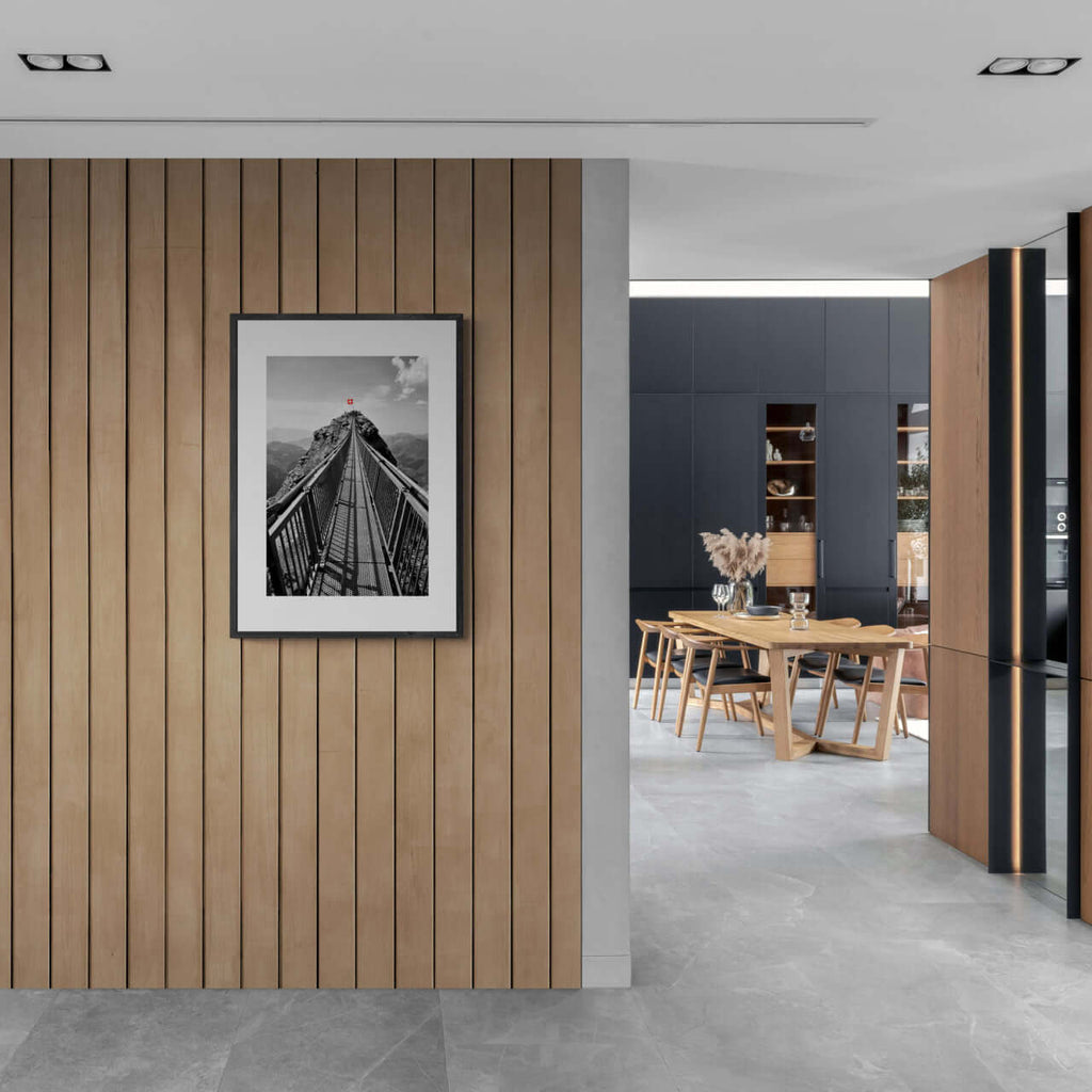 Glacier 3000 Suspension Bridge - Poster framed on wooden wall in modern interior, showcasing dramatic alpine landscape.