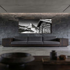 Matterhorn Chalet View – Alu-Dibond wall art displayed in a modern living room with stone wall.