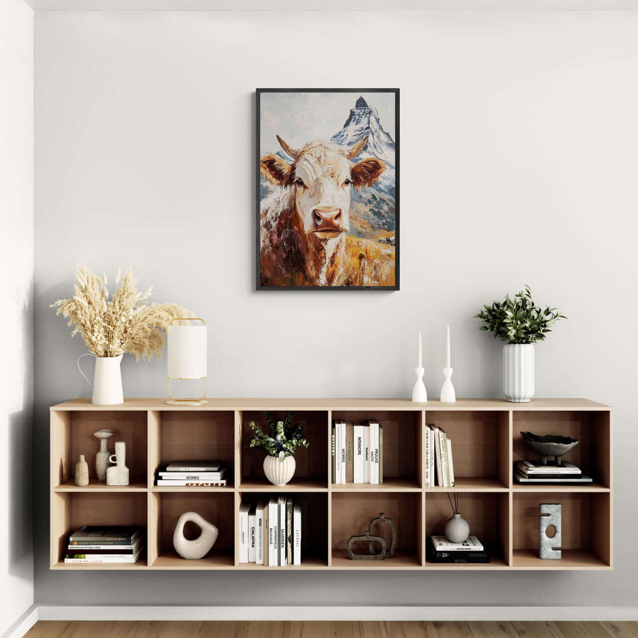 Queen of Zermatt_Poster_black_frame - Poster displayed above a modern shelf with decor items and books.