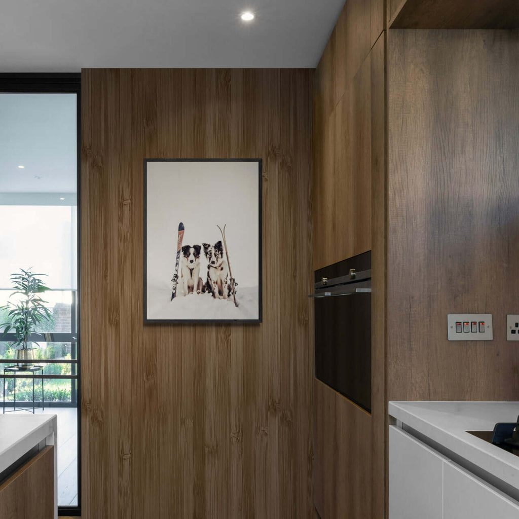 Ski Dogs - Poster displayed in a modern kitchen, showcasing winter charm and alpine spirit with a dog theme.