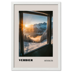 Verbier - The Heart of the 4 Vallées - Poster showcasing a sunrise over snowy mountains framed by a mountain lift window.