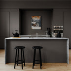 Verbier - Winter Retreat - Poster displayed in a modern kitchen with a marble countertop and black stools.