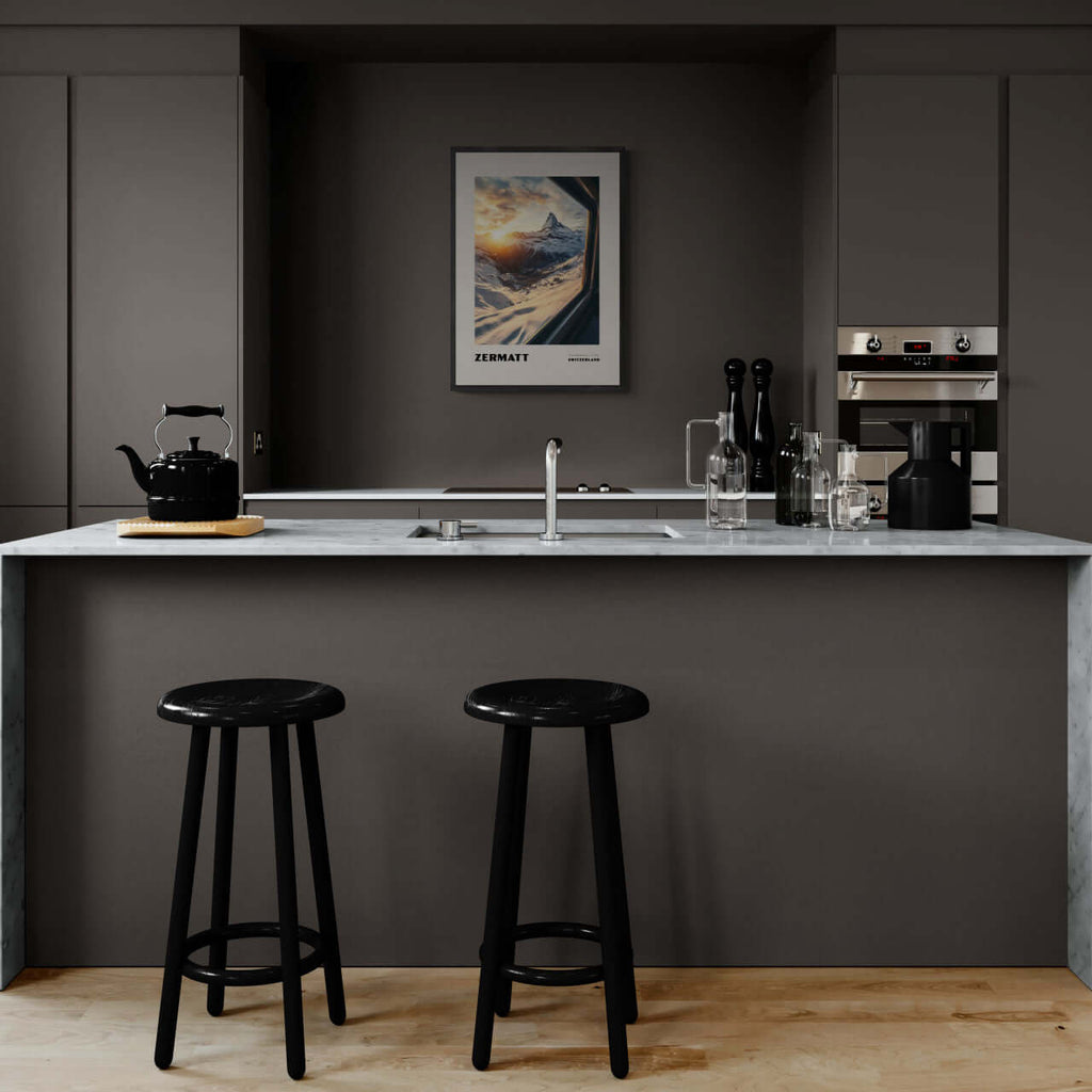 Zermatt - The Matterhorn - Poster displayed in a modern kitchen with black stools and sleek grey cabinetry.